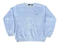 A light blue knit crewneck sweater with a subtle grid pattern and a small embroidered logo on the left chest, 