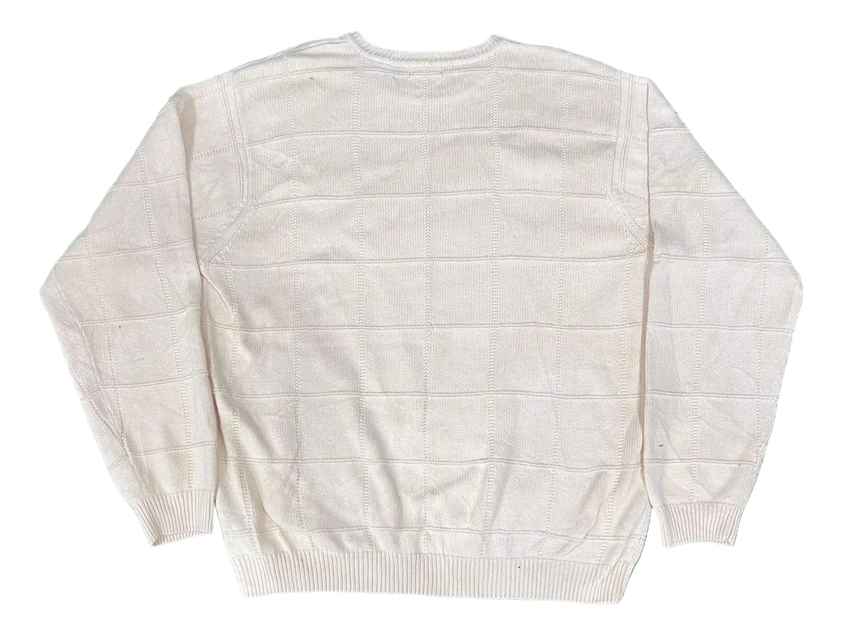 An off-white knit sweater with a subtle grid pattern,
