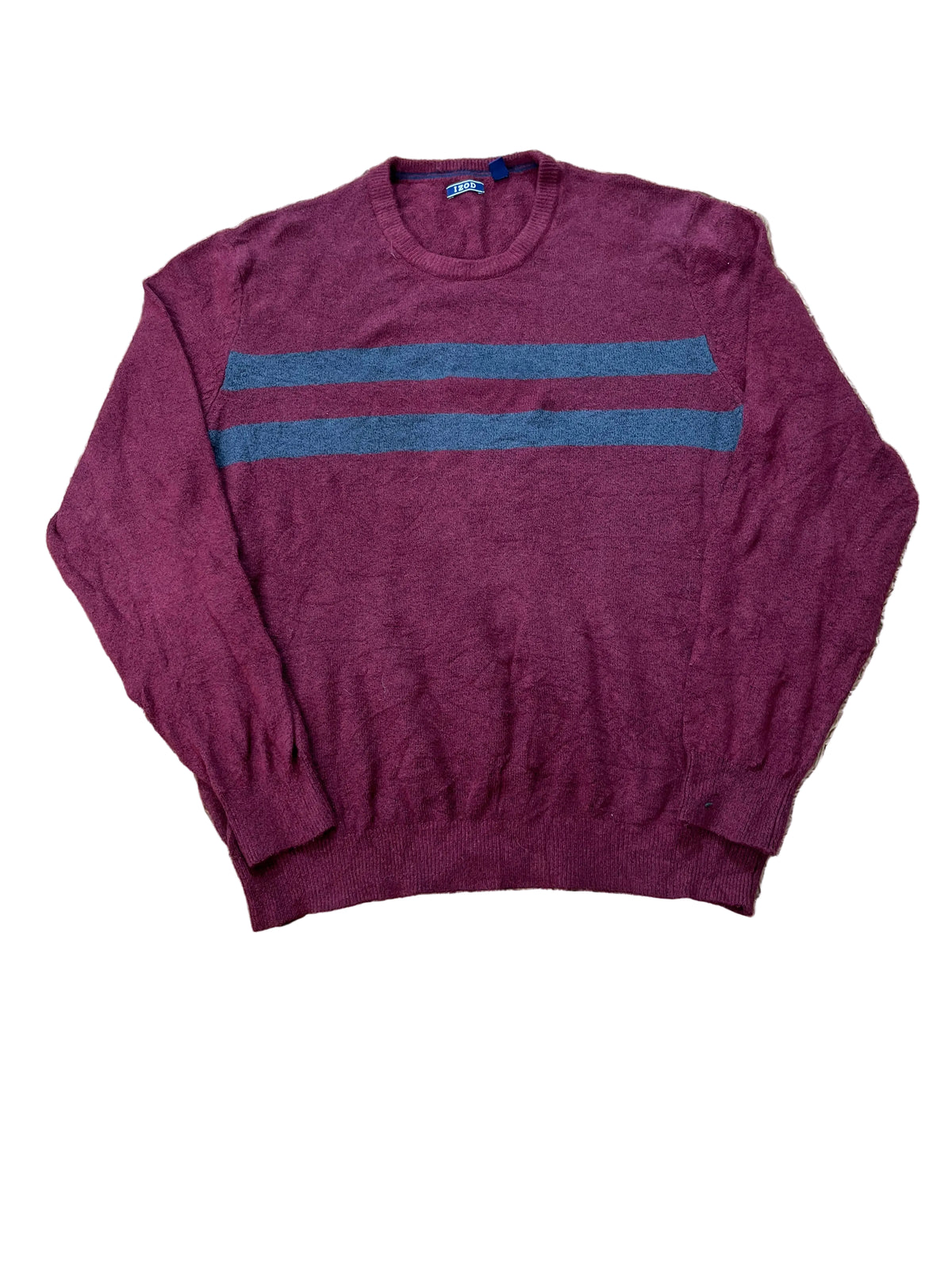 A maroon crewneck sweater with two horizontal blue stripes across the chest,  with bare feet visible at the bottom edge.