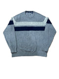 A gray knit crewneck sweater with a thick navy blue horizontal stripe across the chest and a lighter gray textured shoulder yoke,