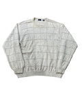 A light beige crewneck sweater with a subtle windowpane grid pattern, . The brand label inside the collar reads 'Burberrys'.