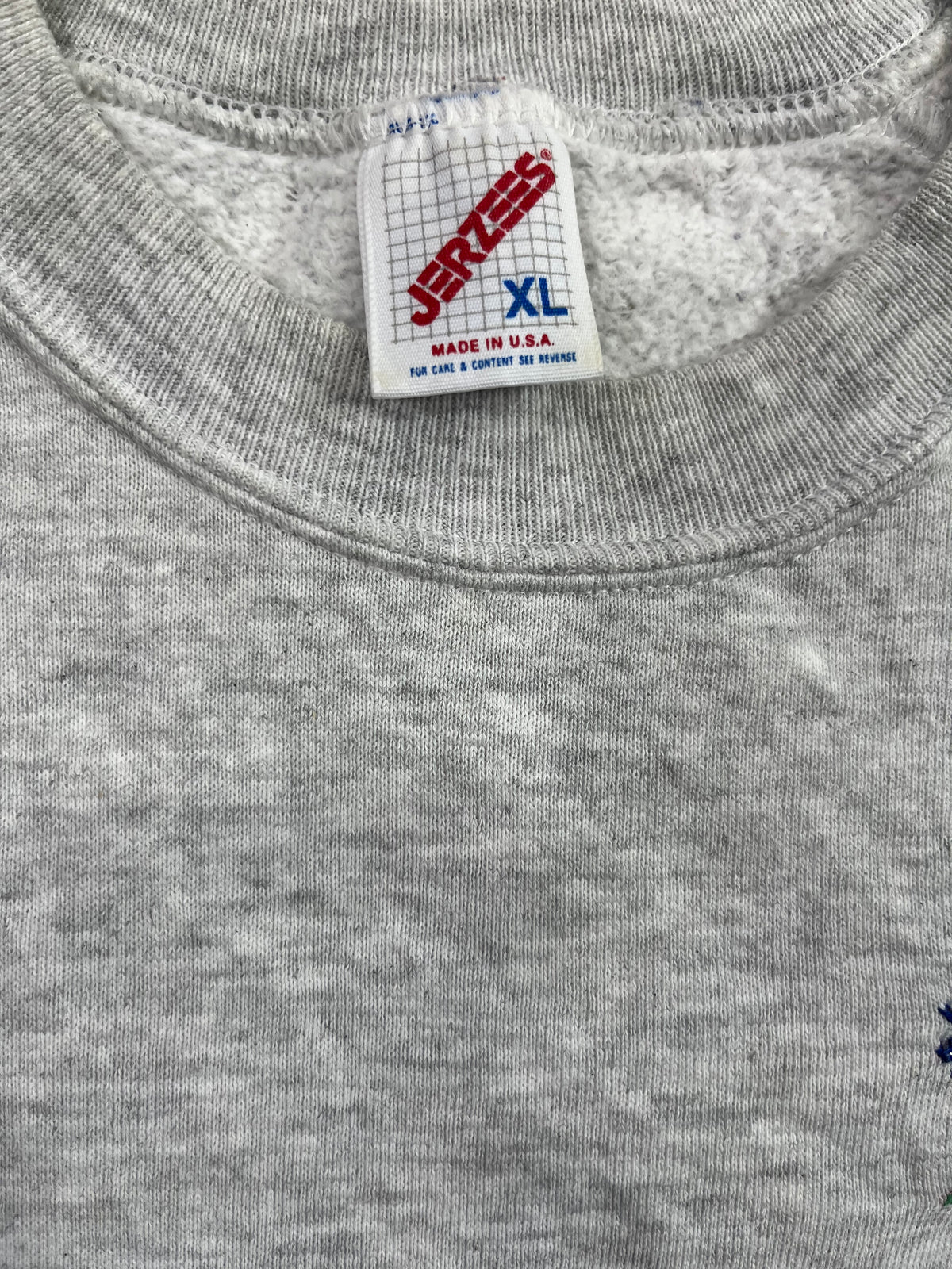 Close-up of a gray heather crewneck sweatshirt showing the inner neck label which reads Jerzees and XL.