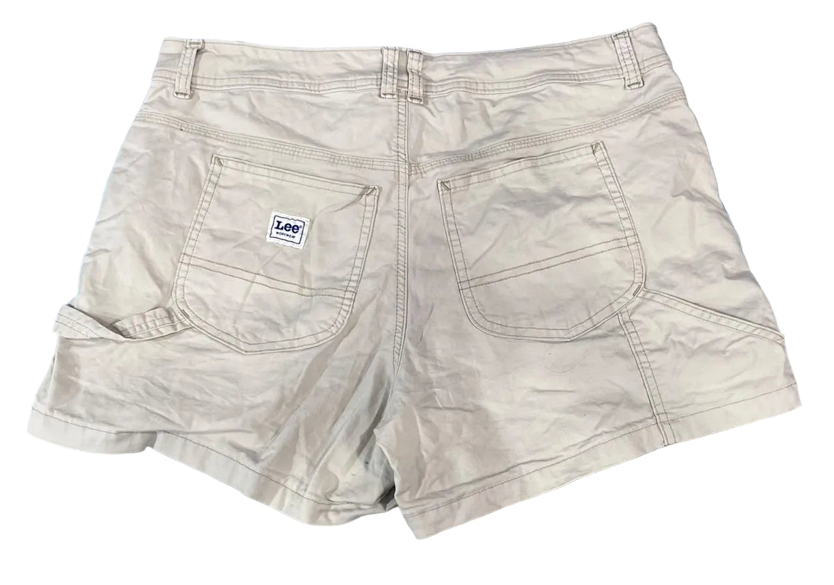 A pair of light beige denim shorts shown from the back, featuring two large patch pockets and a small white 'Lee' brand label on the left pocket, 