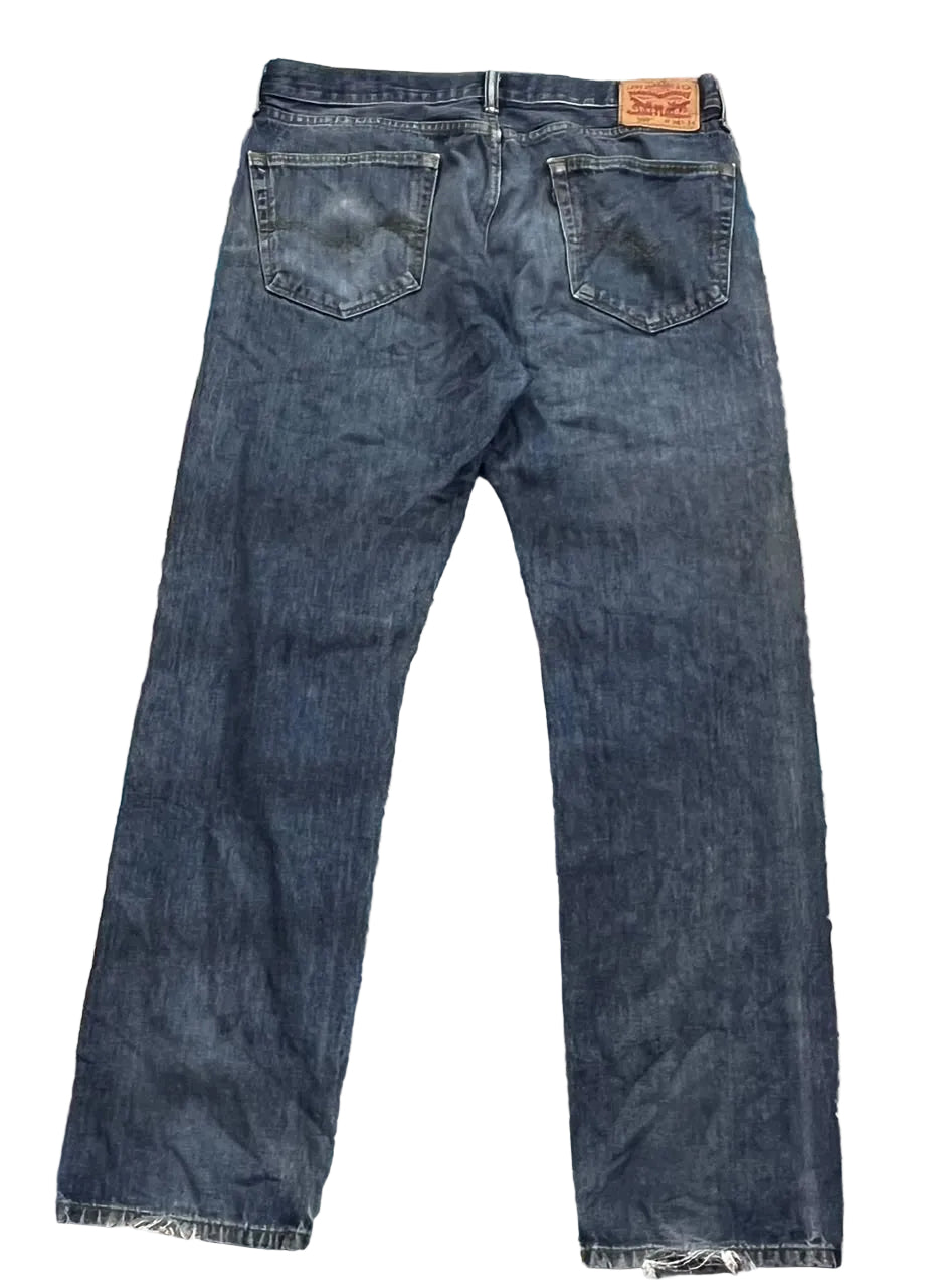 A pair of dark blue denim jeans shown from the back,  The iconic orange Levi's brand patch is visible on the back waistband.