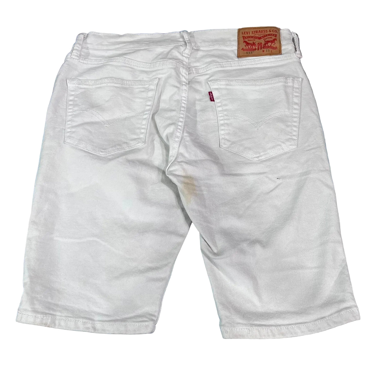 White Levi's denim shorts viewed from the back, The iconic brown leather patch and red tab are visible.