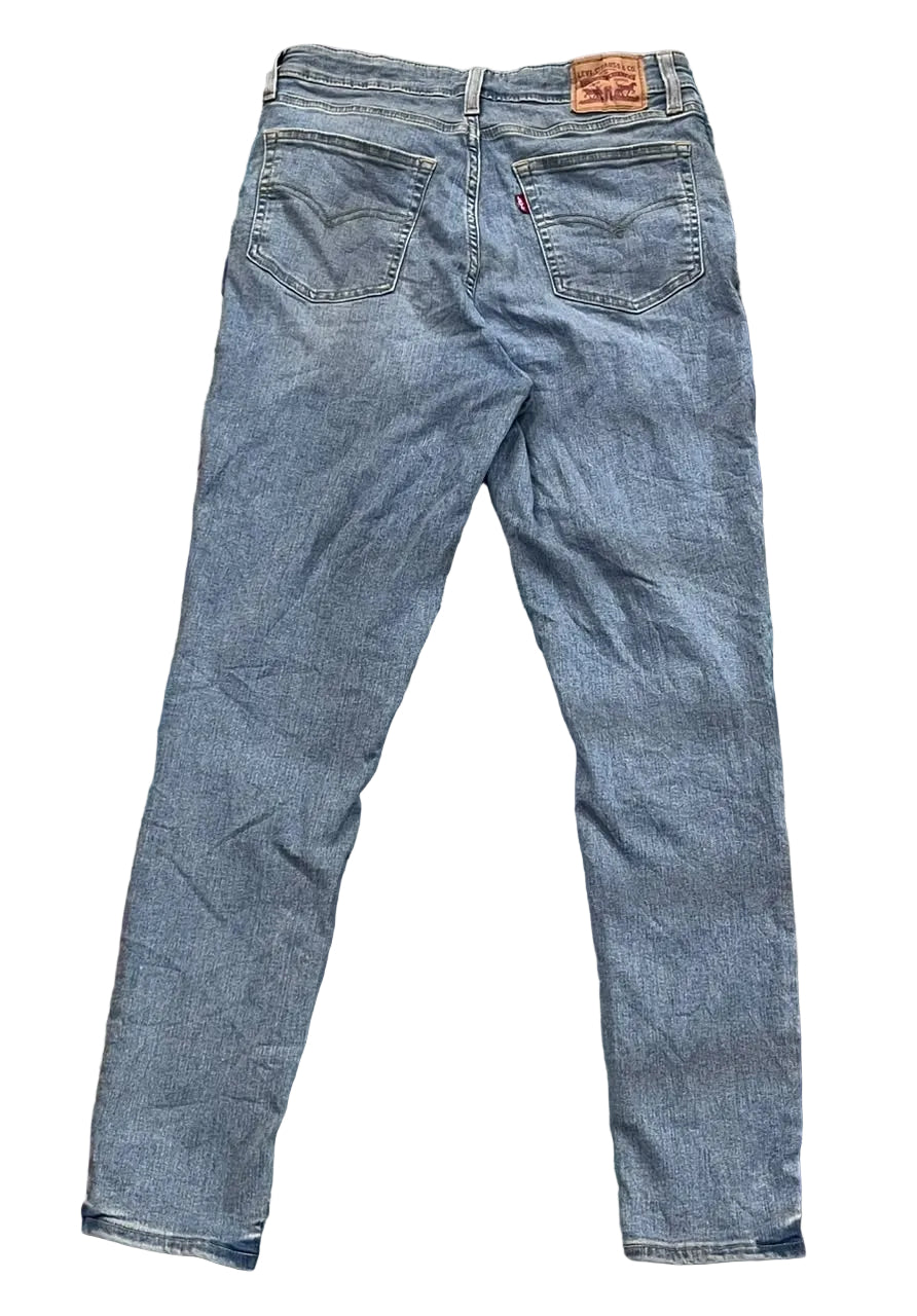 A pair of blue Levi's slim-fit jeans  The back pockets and the classic brown leather Levi's patch are visible at the waist.