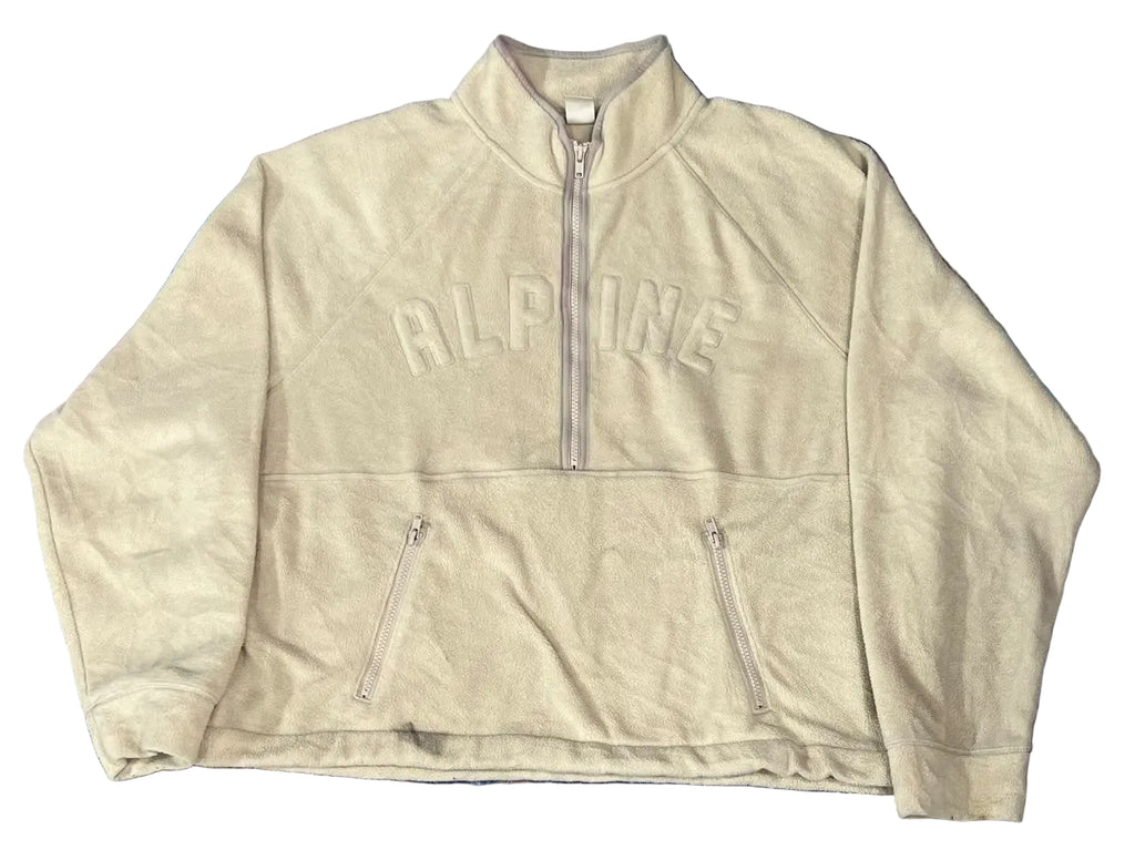 A cream-colored suede half-zip jacket with 'ALPINE' embroidered across the chest,