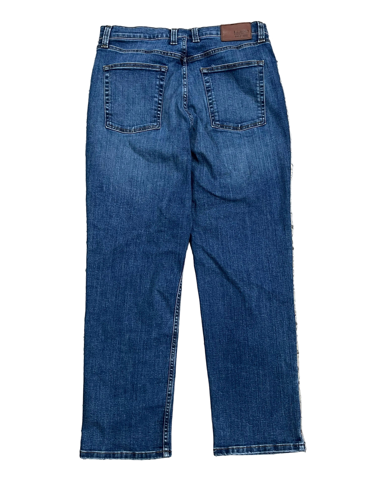 A pair of blue denim jeans shown from the back