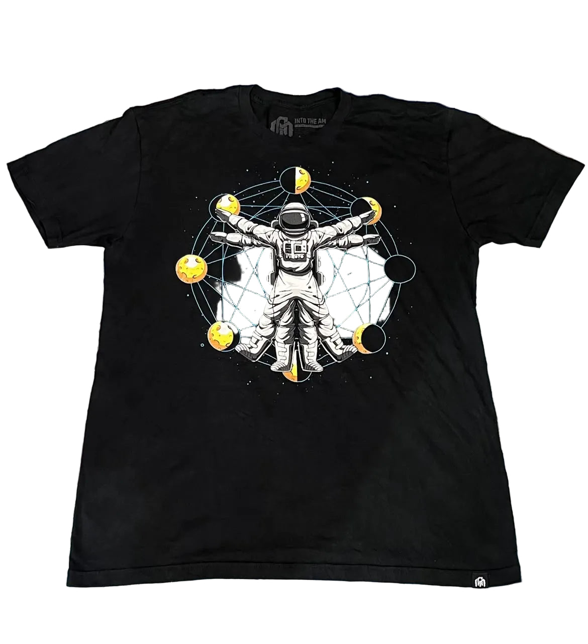 A black short-sleeve graphic t-shirt The graphic features an astronaut in a white spacesuit surrounded by yellow celestial bodies and a circular network.