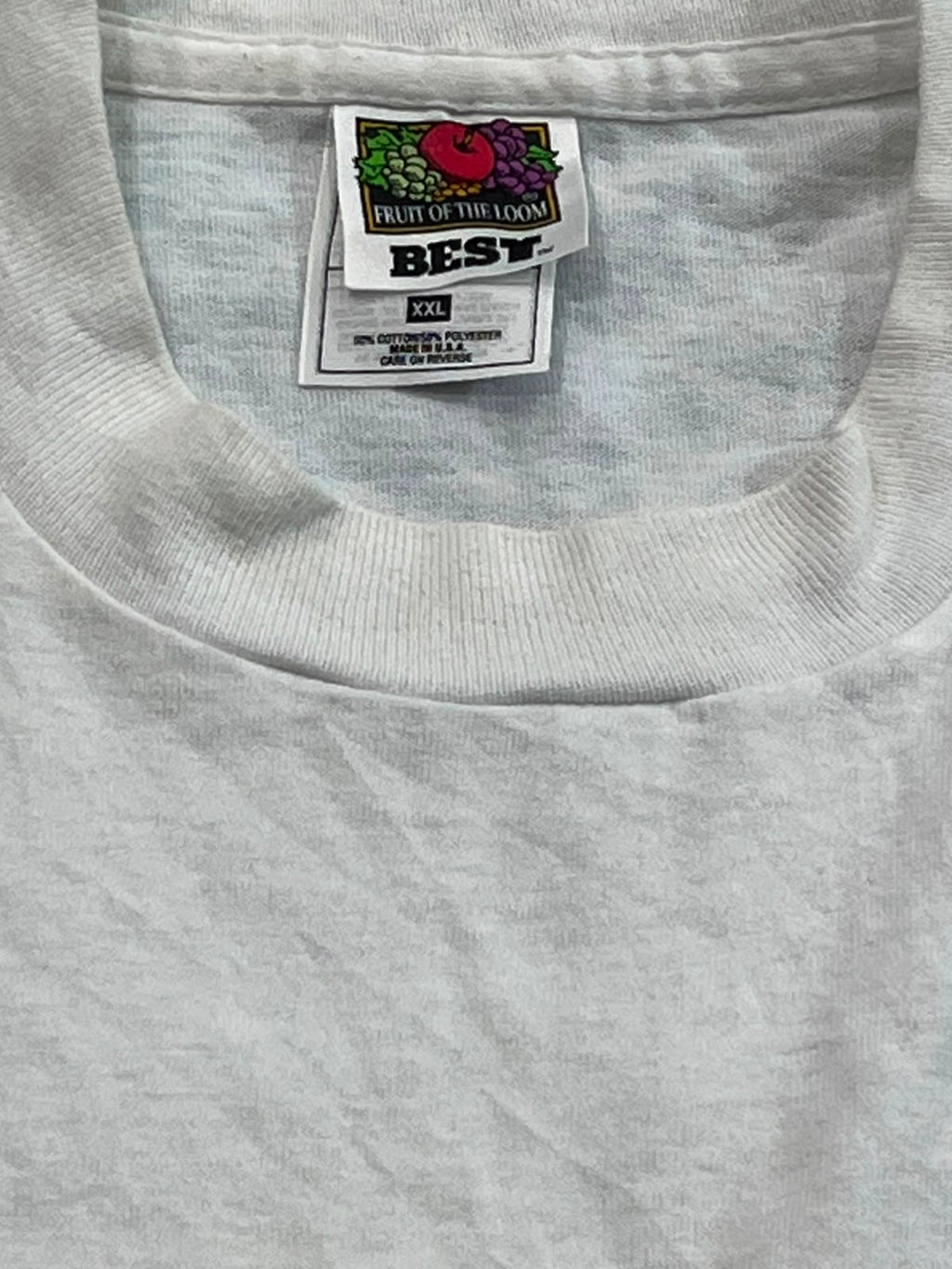 Close-up of a light gray heather crewneck t-shirt showing the inner neck label which reads 'FRUIT OF THE LOOM BEST'.