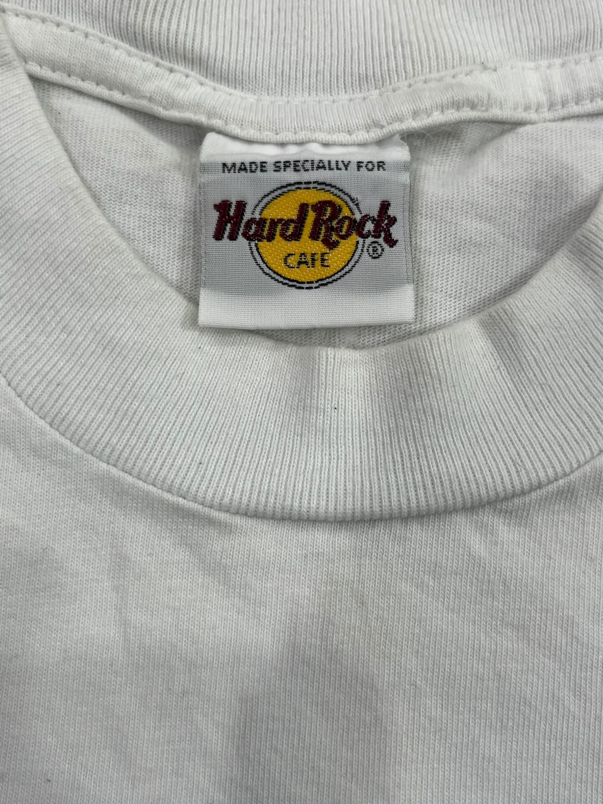 Close-up of a white crewneck t-shirt showing the inner neck label which reads 'Made specially for Hard Rock Cafe'.