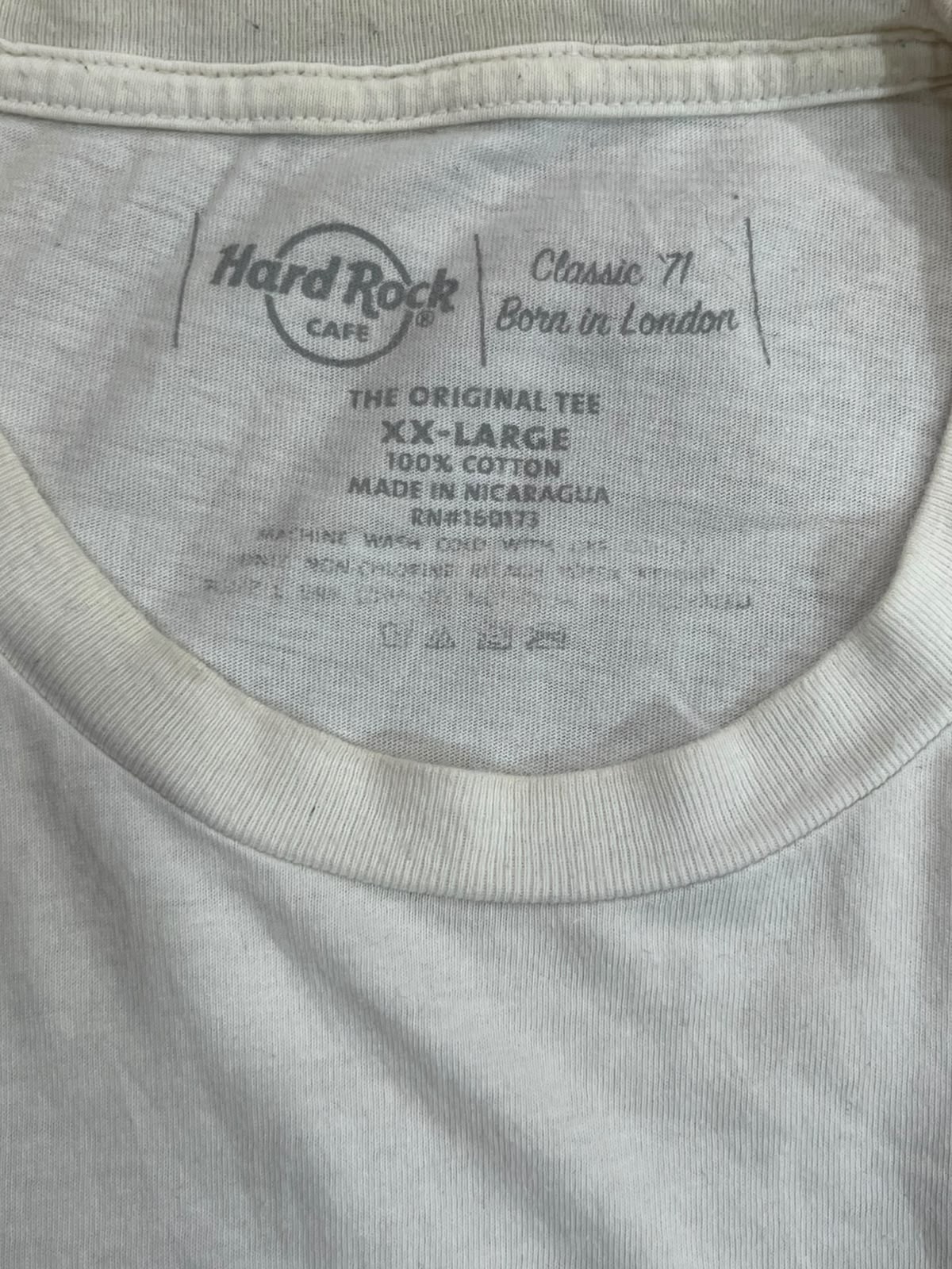 Close-up of the inside collar of a light gray or off-white cotton t-shirt, showing the printed Hard Rock Cafe brand label and text including 'Classic 71' and 'The Original Tee'.