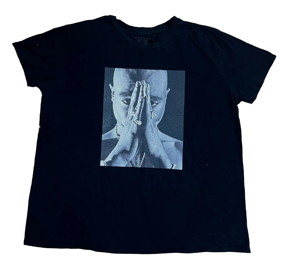 A black short-sleeve t-shirt  featuring a square graphic print of a person with hands over their face in a blue-toned photo.