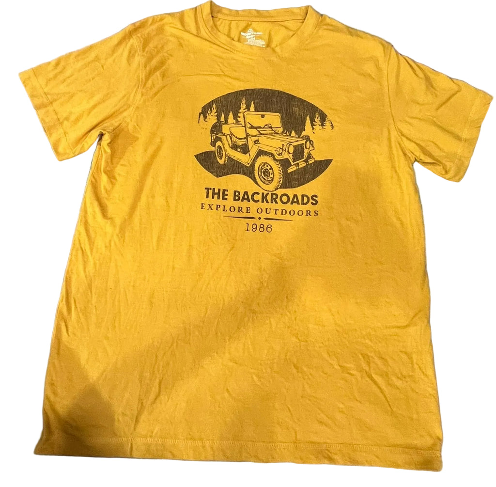 A yellow short-sleeve graphic t-shirt  The shirt features a black graphic of a vintage jeep in a forest with the text 'THE BACKROADS EXPLORE OUTDOORS 1986'.