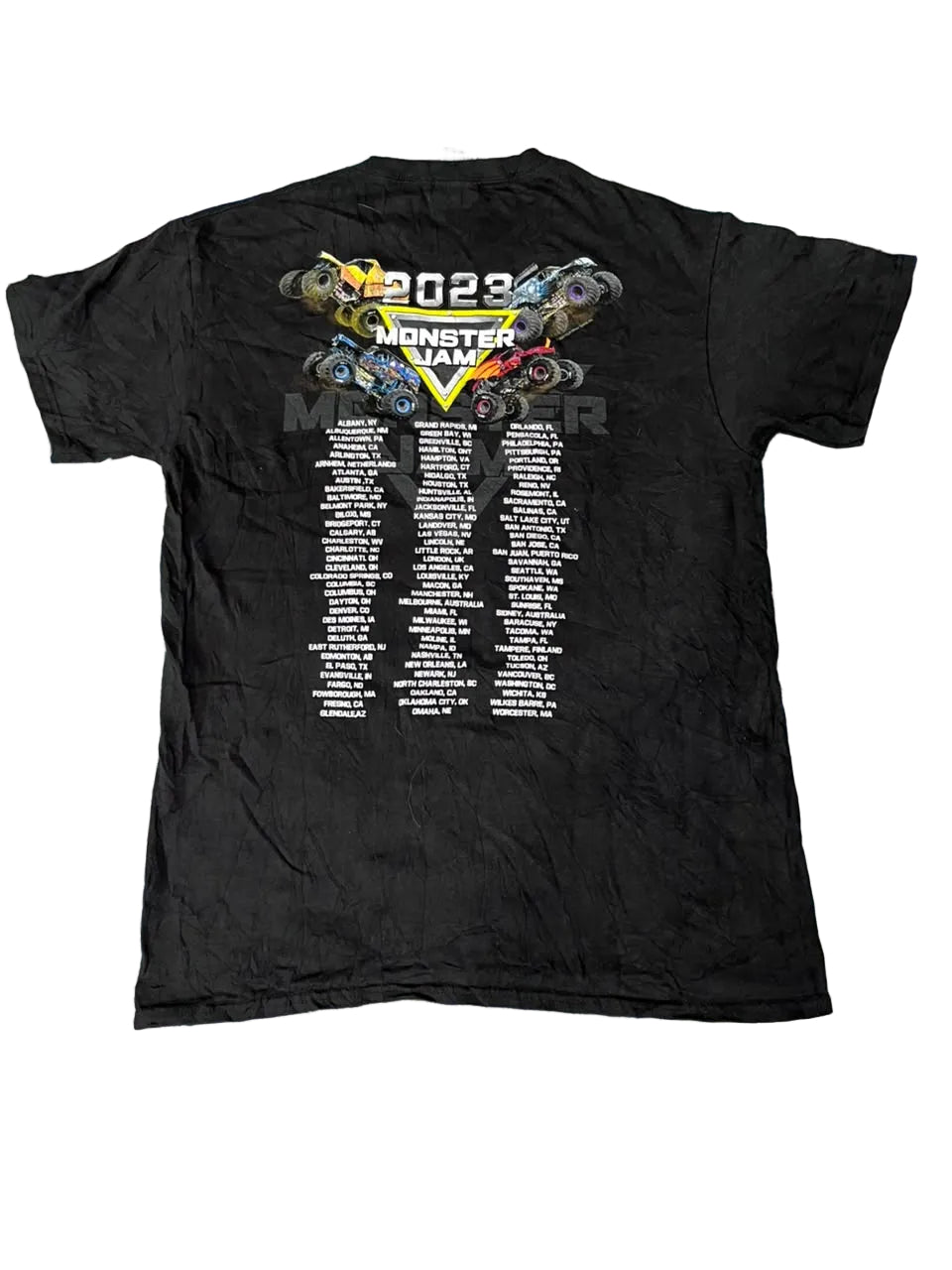 A black short-sleeve t-shirt , showing the back graphic for the 2023 Monster Jam championship with a list of winners.