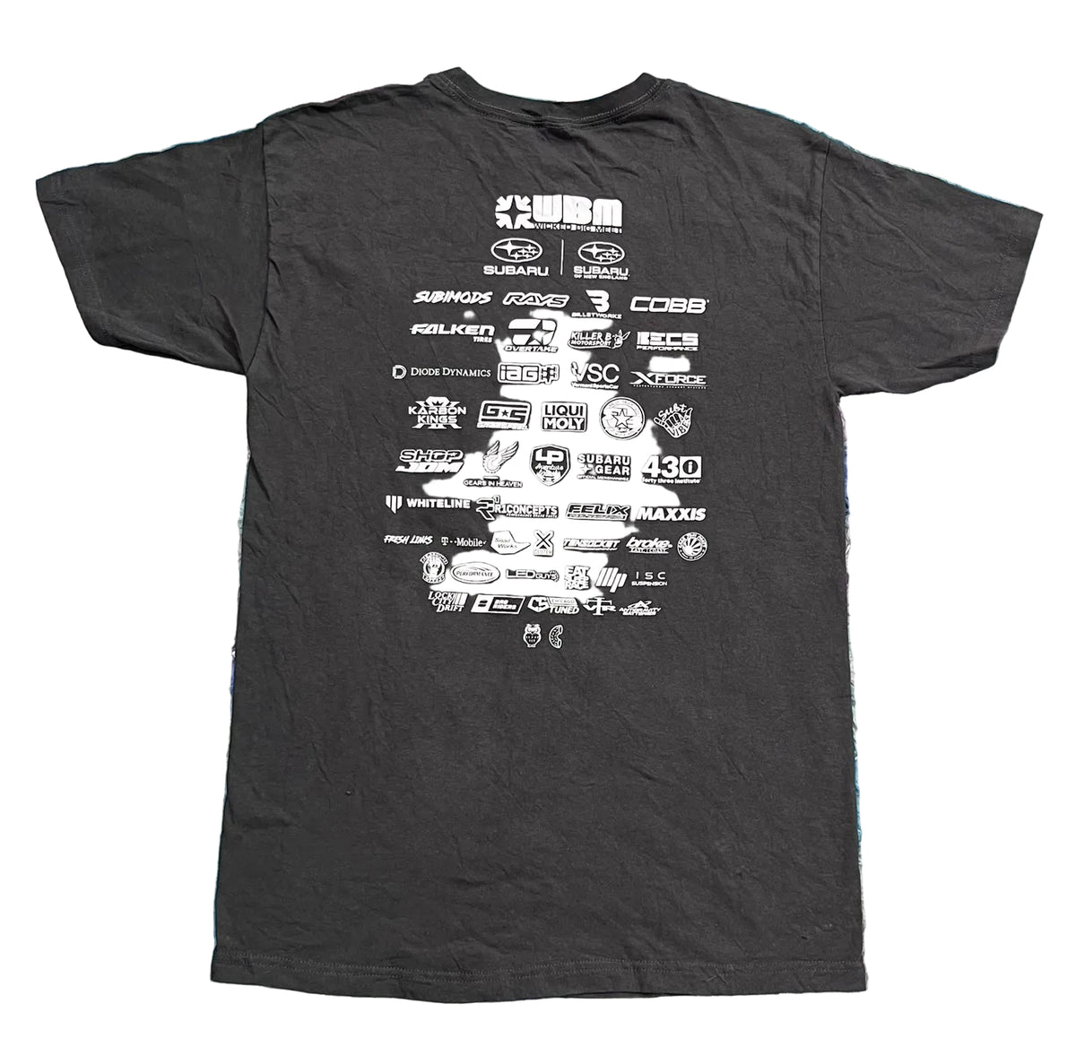 A black short-sleeve t-shirt The back of the shirt features a large white grid of various automotive sponsor logos, including Subaru, Ford, and Mazda.