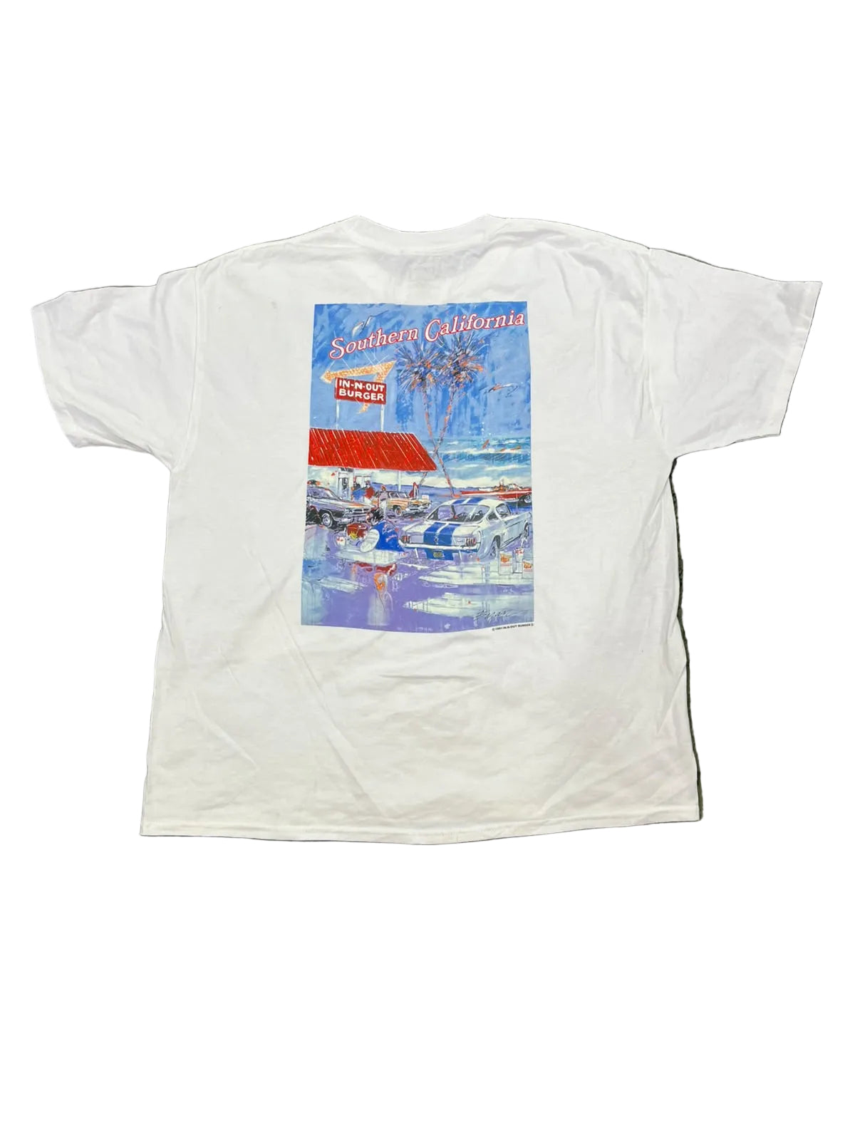 A white short-sleeve t-shirt showing a colorful graphic print on the back with the text 'Southern California' and a beach scene.