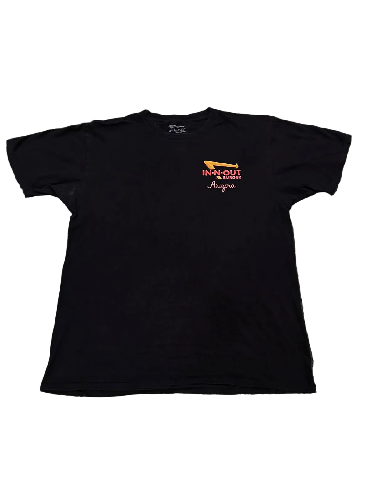 A black short-sleeve t-shirt with a small orange and white graphic on the left chest reading 'INK OUT LAS VEGAS
