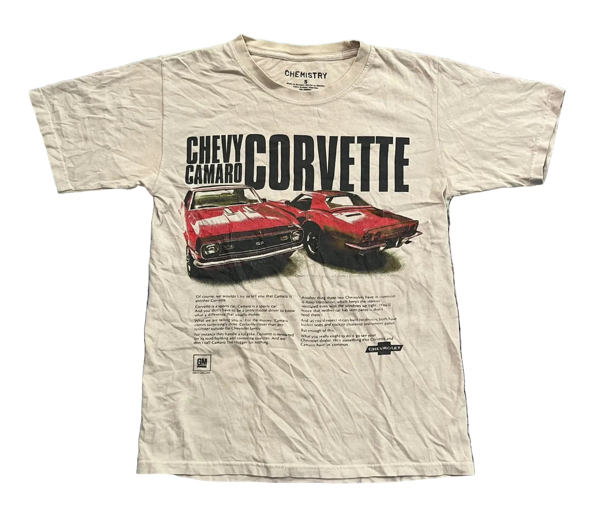 A vintage cream-colored short-sleeve t-shirt featuring a graphic print of a red Chevrolet Camaro and Corvette with black text,