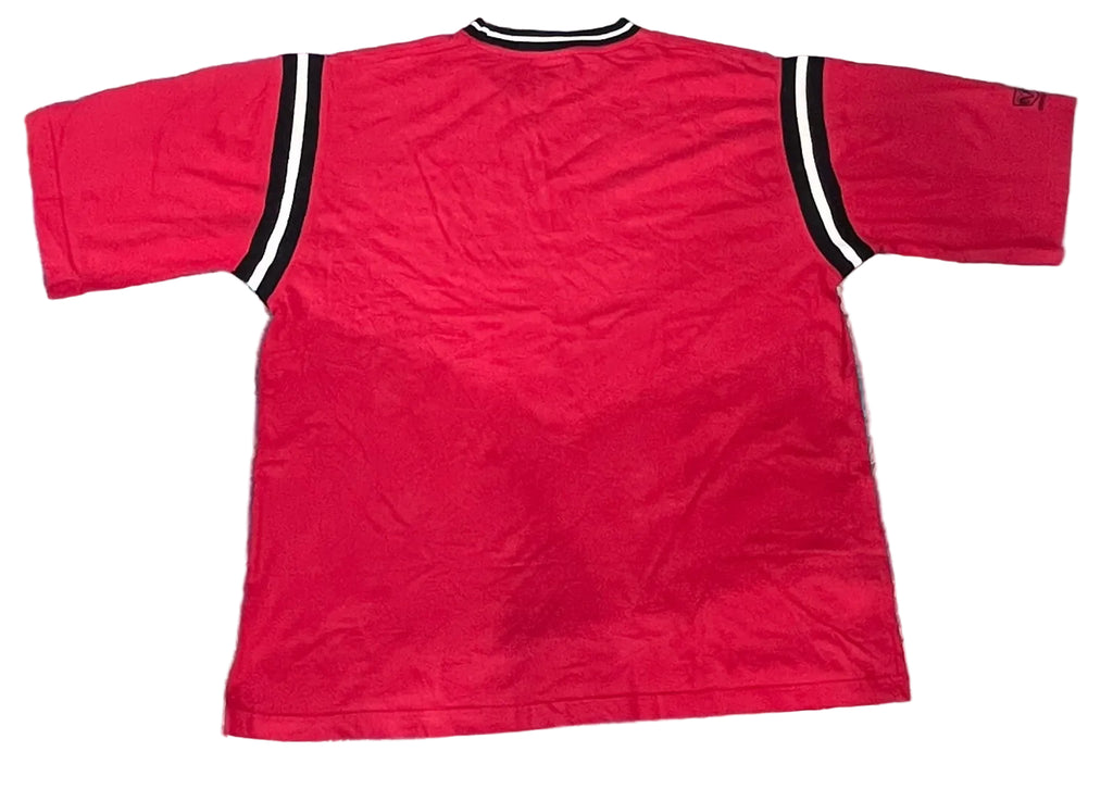 A red short-sleeve t-shirt with black and white striped shoulder accents, 