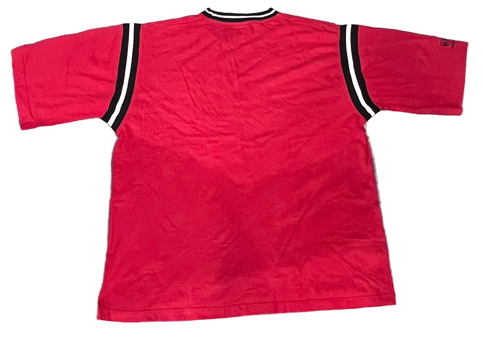 A red short-sleeve t-shirt with black and white striped shoulder accents, 