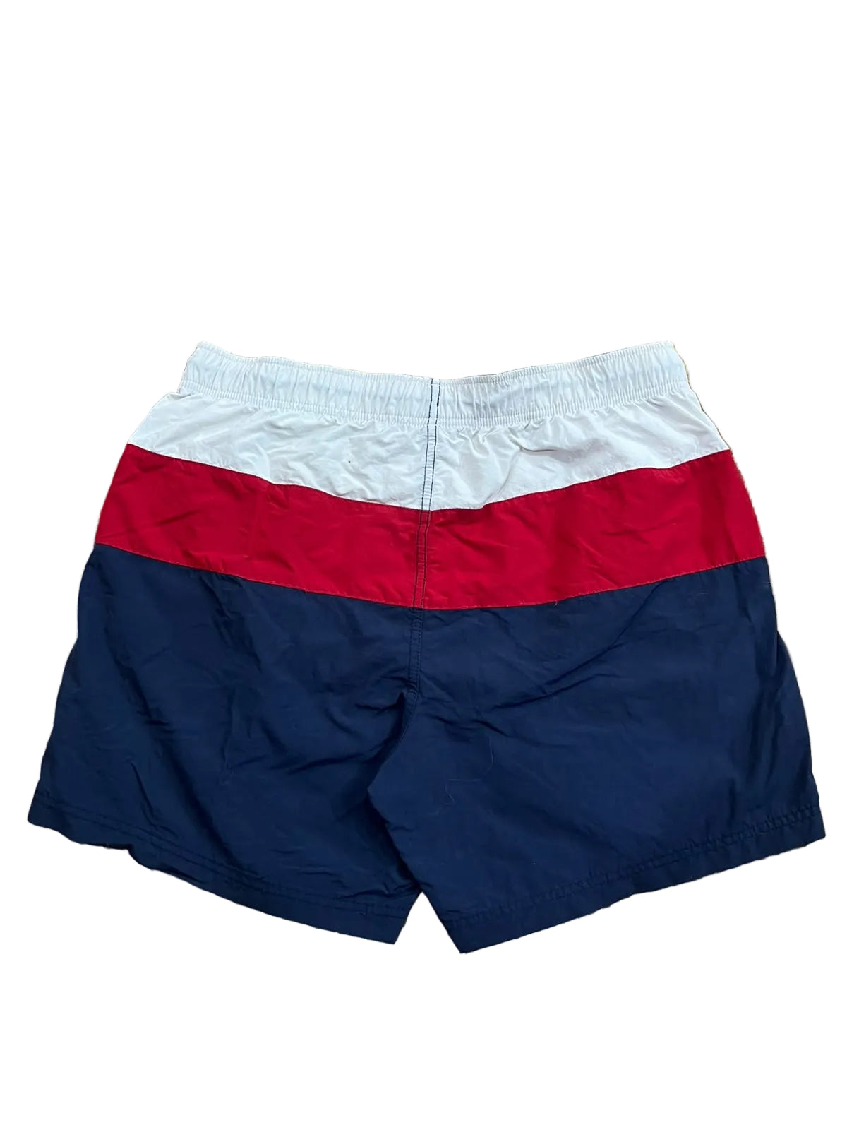 Colorblock swim trunks in white, red, and navy blue,