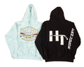 Two hoodies a light blue hoodie with a large multicolor chest graphic reading 'Duluth' and a black hoodie with a large white hockey-themed back graphic and vertical white text on the sleeve.
