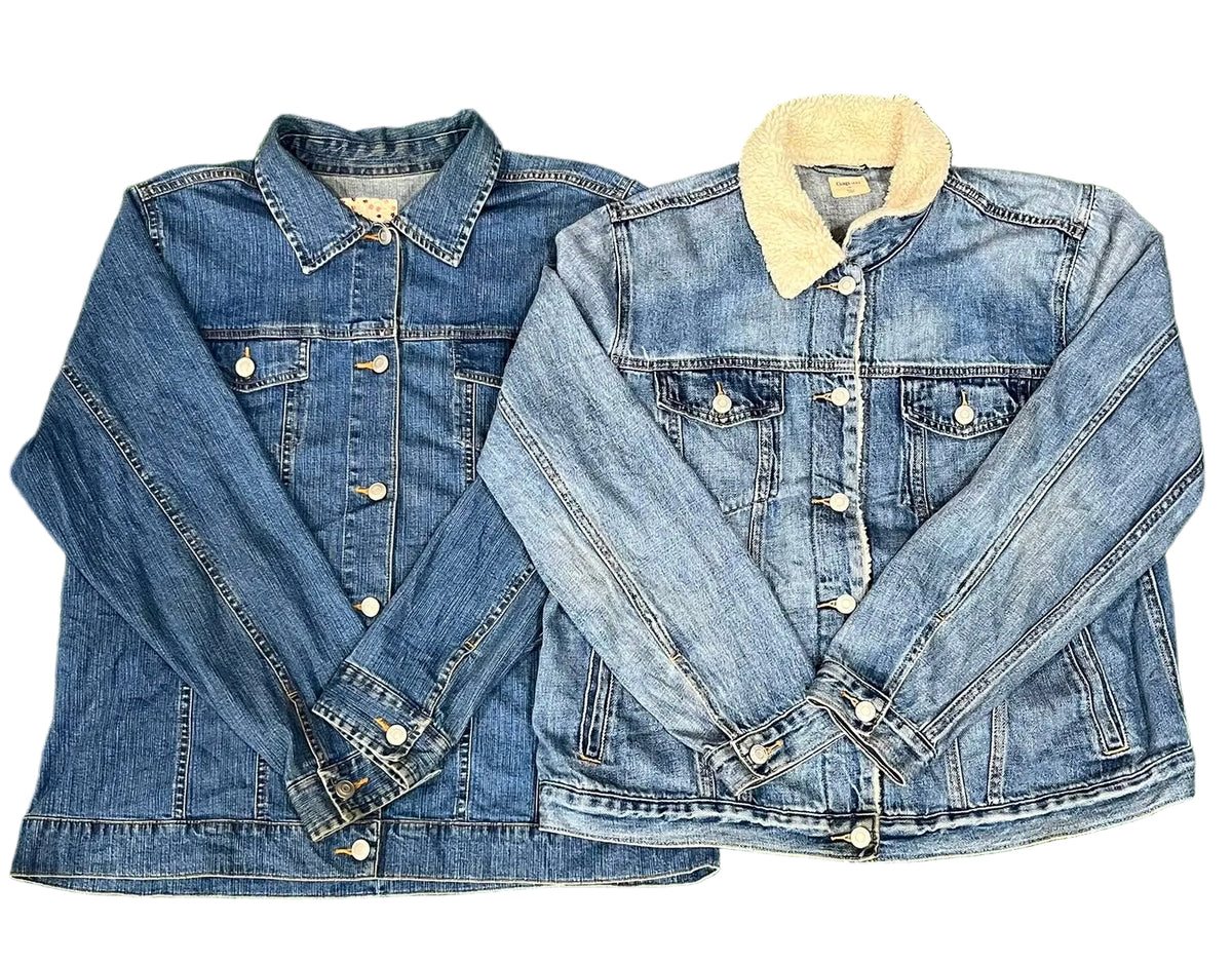 Two denim jackets. The left jacket is a medium wash blue denim with silver buttons.
