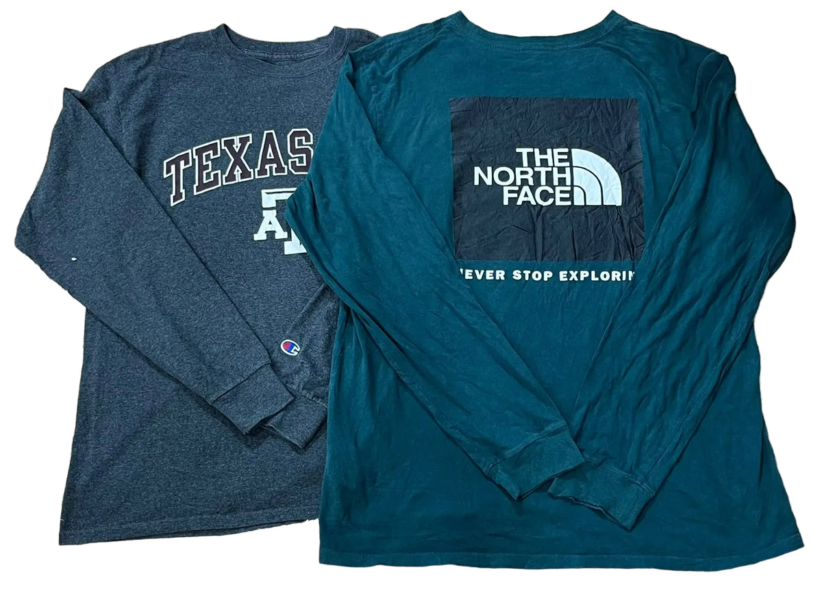 Two long-sleeve shirts.The left shirt is dark heather gray with a white 'TEXAS' and 'A' graphic, and a small Champion logo near the cuff.