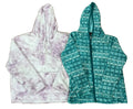 Two hooded sweatshirts: a fuzzy lavender-and-white tie-dye hoodie on the left and a teal zip-front hoodie with a white geometric pattern on the right.