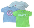 Three kids' short-sleeve graphic t-shirts : a light gray Champion t-shirt at the top, a heather blue St. Mary's Beach Florida t-shirt on the left, and a bright green Glen Hope Gators t-shirt on the right.