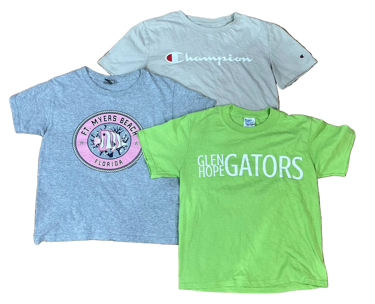 Three kids' short-sleeve graphic t-shirts : a light gray Champion t-shirt at the top, a heather blue St. Mary's Beach Florida t-shirt on the left, and a bright green Glen Hope Gators t-shirt on the right.