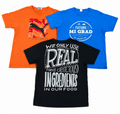 Three graphic t-shirts displayed together on a white background: an orange Puma shirt, a blue 'Future Mi Grad' shirt, and a black shirt with a white typographic design.