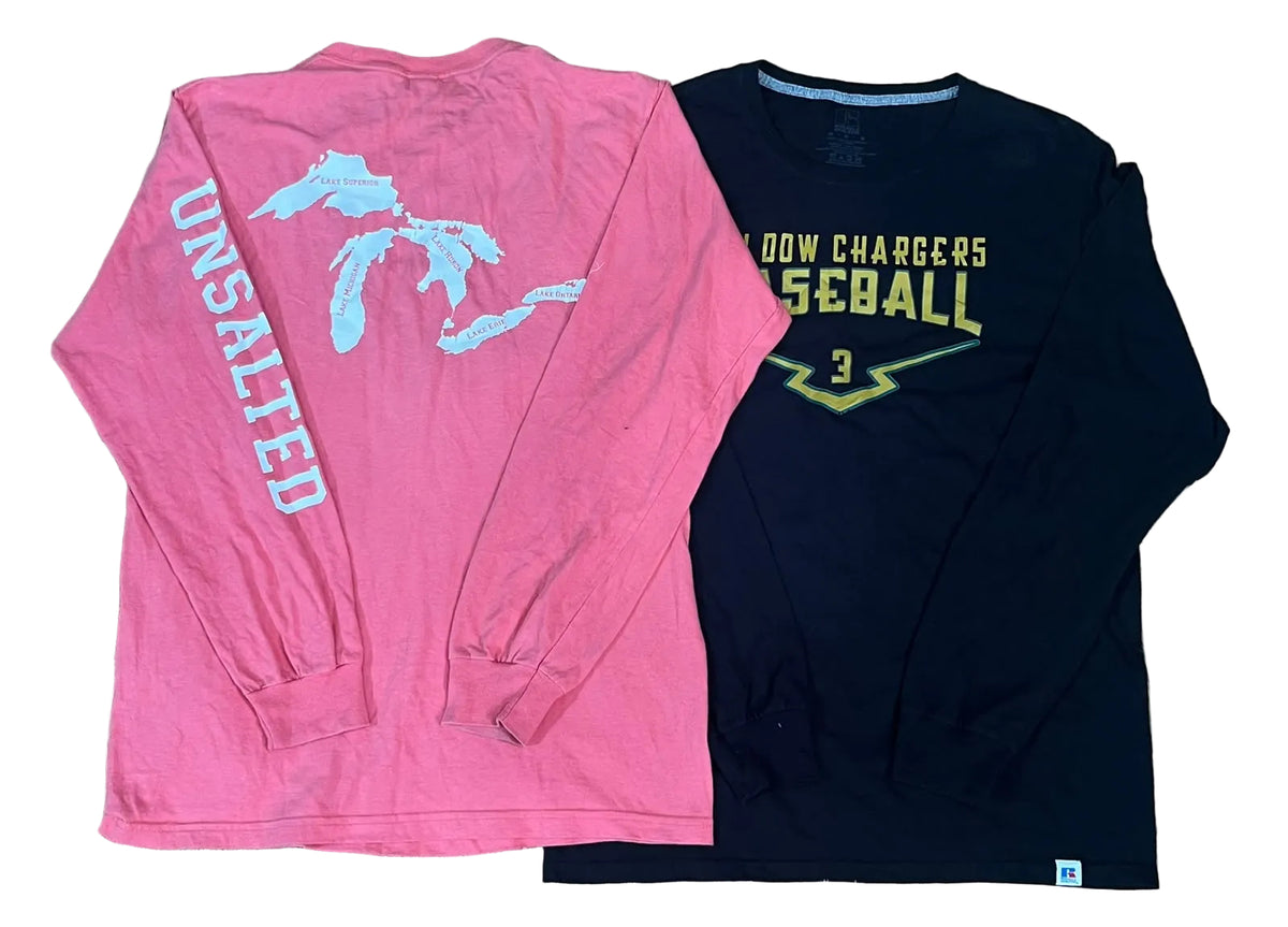 Two long-sleeve shirts. The left shirt is bright pink with a light blue Michigan map graphic on the back and the word 'UNSALTED' printed vertically in light blue on the left sleeve.