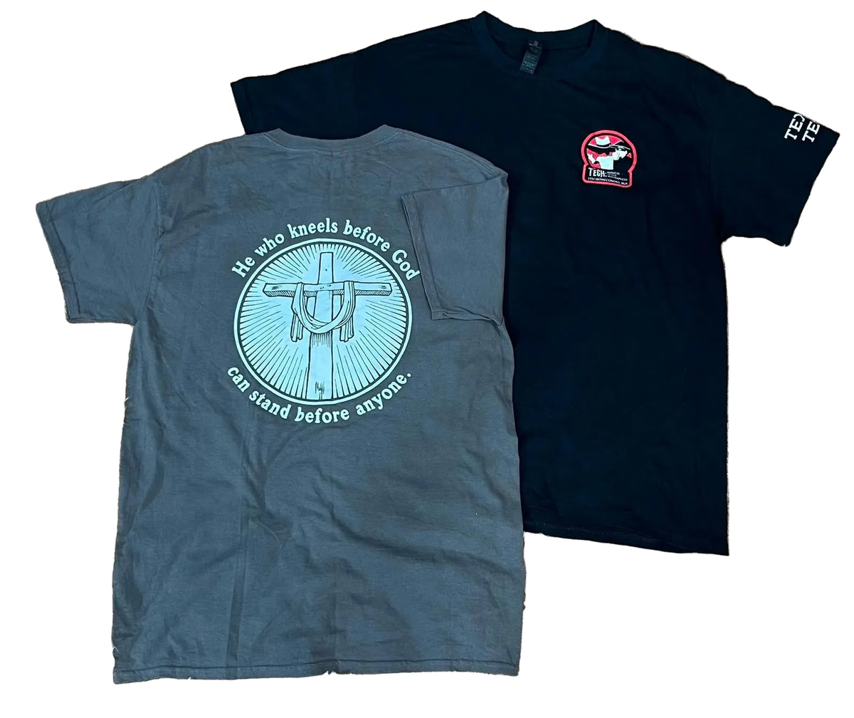 Two short-sleeve graphic T-shirts The front shirt is dark charcoal gray with a large light blue circular cross graphic and text on the back, and the rear shirt is black with a small red-and-white chest graphic and white text on the sleeve.