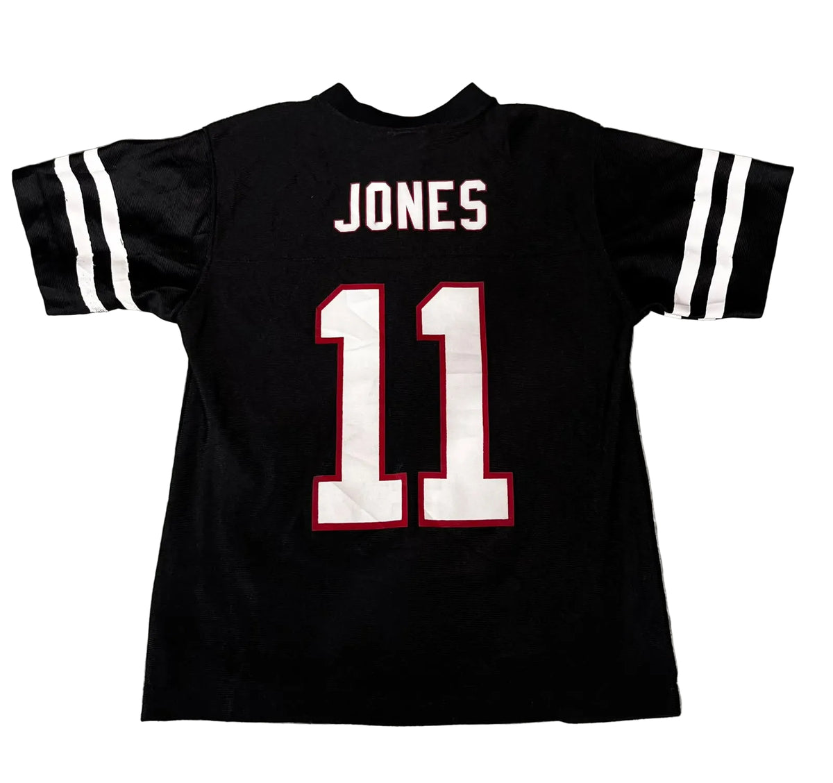A black football jersey featuring the name JONES in white block letters with a red outline and the number 11 in white with a red outline on the back. The sleeves have white stripes.