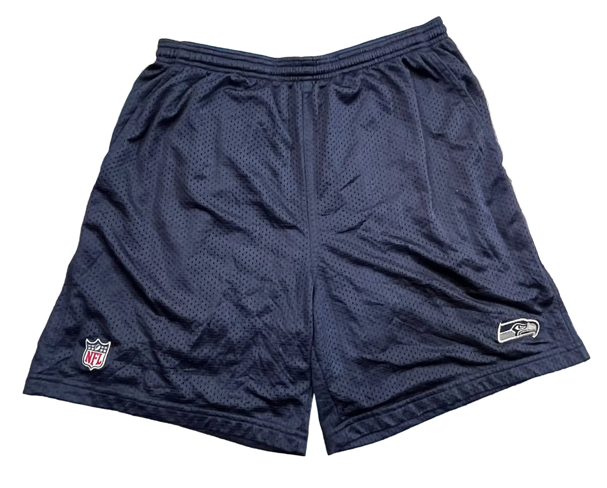 Navy blue mesh Seattle Seahawks athletic shorts with an NFL shield logo on the left leg and a Seahawks logo on the right leg,