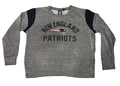 A heather gray long-sleeve crewneck sweatshirt with navy blue shoulder panels and 'NEW ENGLAND PATRIOTS' text with the team logo on the chest
