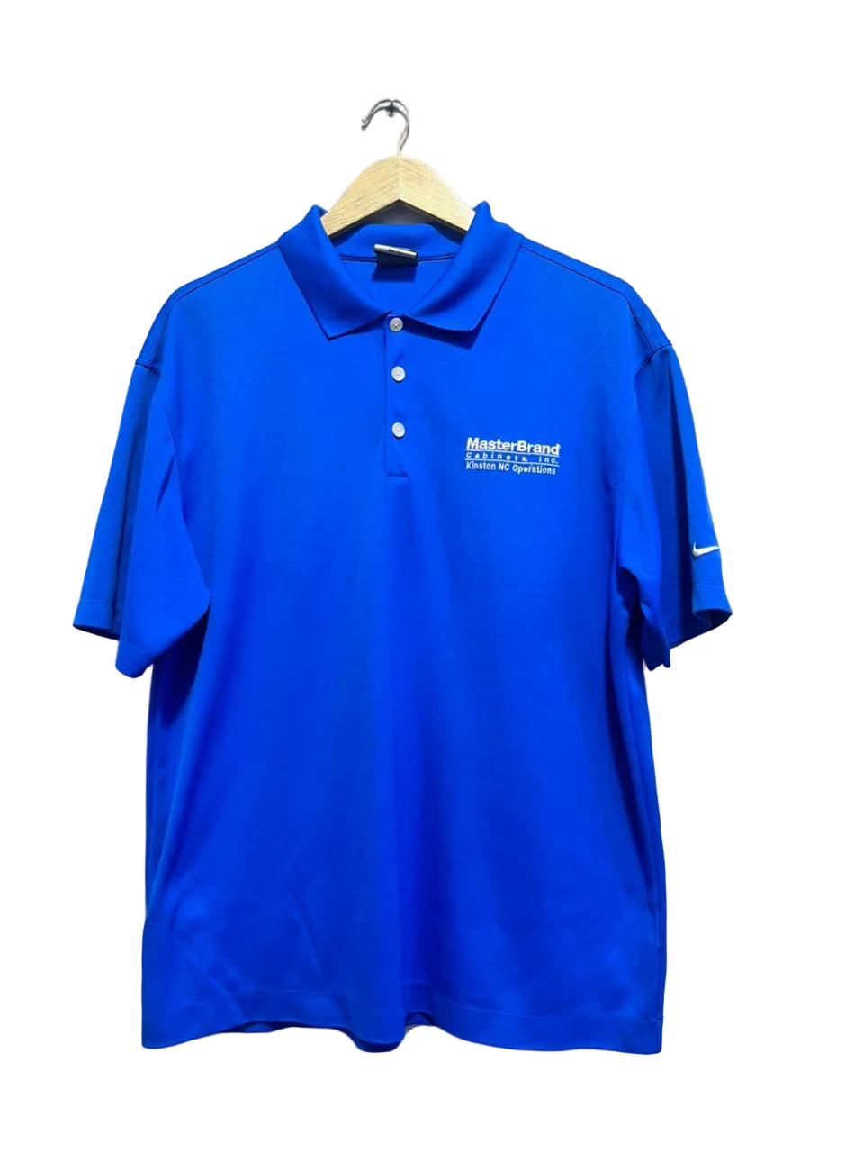 Nike blue men polo shirt with a logo on a hanger against a white wall