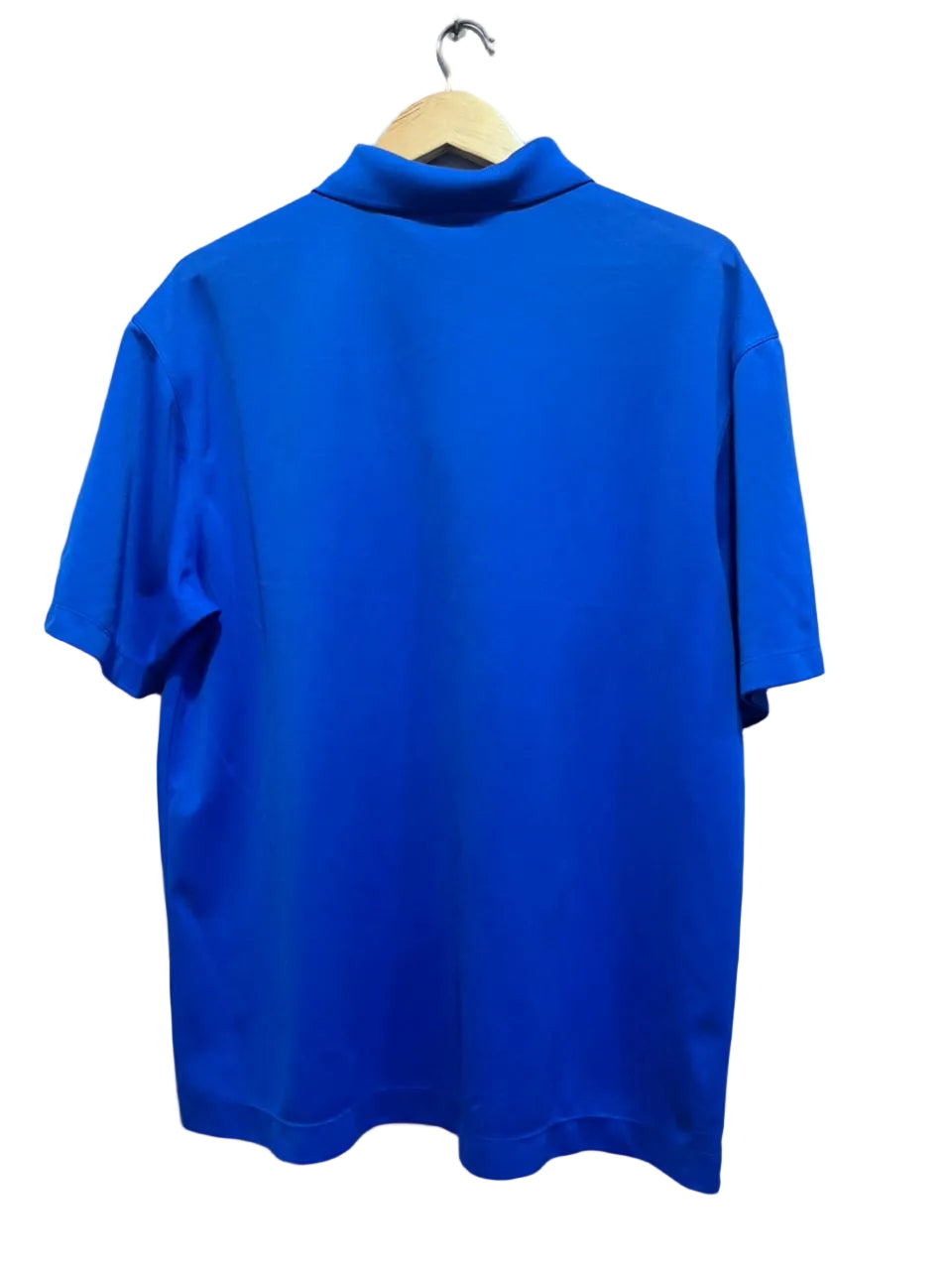 Nike blue men  polo shirt on a hanger against a white wall