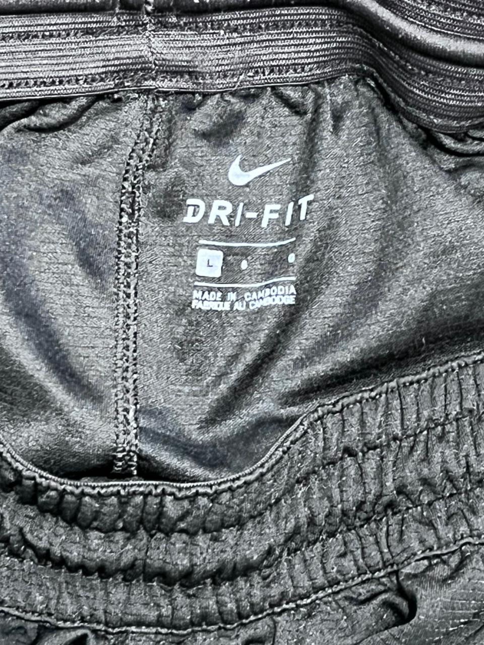 Close-up of a Nike Dri-FIT label on athletic clothing.