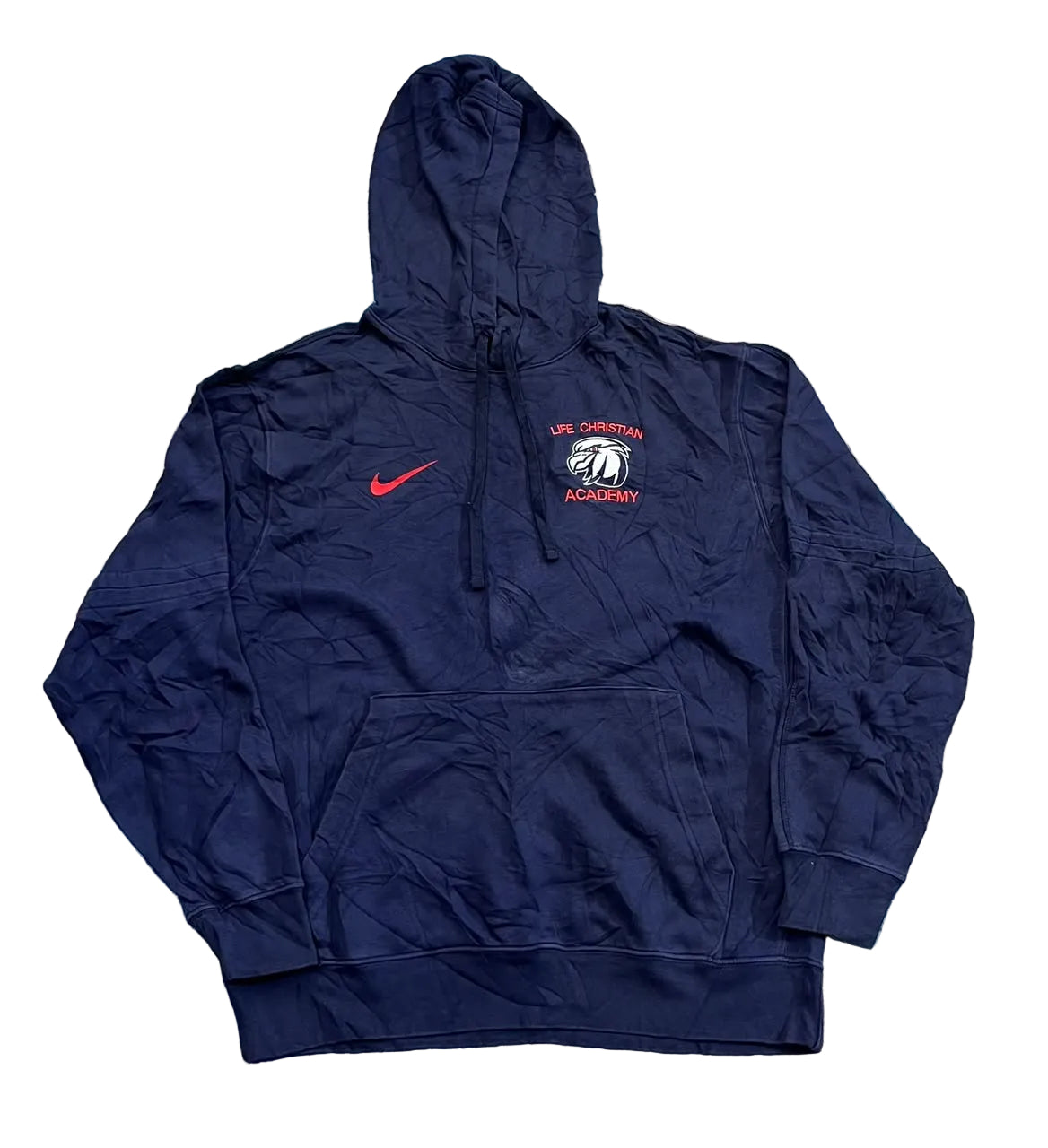 A navy blue Nike pullover hoodie with a red swoosh on the left chest and a 'Life Christian Academy' eagle logo on the right chest,