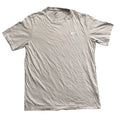 A light beige Nike short-sleeve t-shirt with a small white logo on the left chest, 