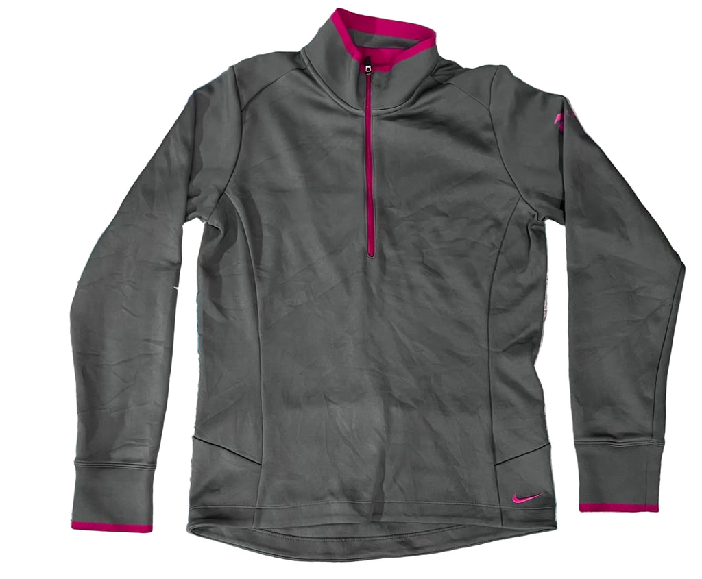 A dark gray Nike long-sleeve quarter-zip athletic pullover with bright pink accents on the collar, zipper, cuffs, and a small swoosh logo near the lower hem, 