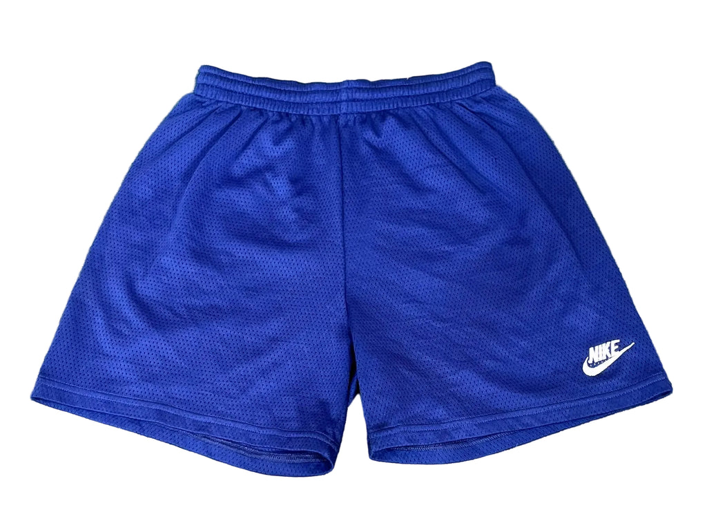 Blue Nike athletic shorts with a white logo on the lower left leg, 