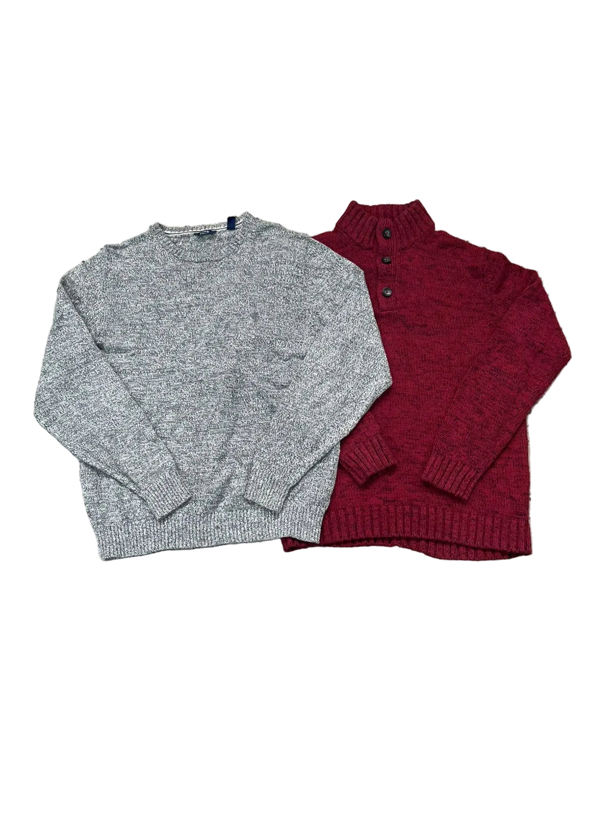 Two knit sweaters laid flat on a speckled floor: a heather gray crewneck sweater and a burgundy mock-neck button-front sweater.