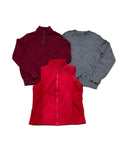 Three women's winter tops a burgundy mock-neck long-sleeve top, a gray crew-neck long-sleeve top, and a red quilted zip-front vest.