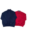 Two quarter-zip knit pullovers one dark navy blue and one bright red, with a small pair of bare feet visible at the bottom edge.
