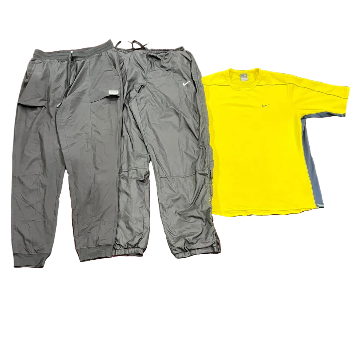 A pair of gray athletic jogger pants and a bright yellow Nike running t-shirt with gray side panels,