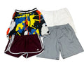 Four pairs of athletic shorts a multicolor abstract-print pair, a white pair, a maroon pair with white side stripes, and a light gray pair.